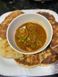 Naan bread with spicy chicken masala sauce