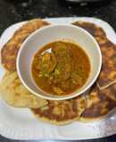 Naan bread with spicy chicken masala sauce