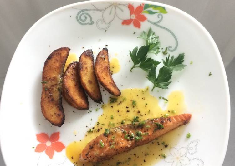 Salmon grilled lemon cheese sauce with potato wedges