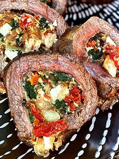 A picture of Wagyu Flank Steak Stuffed With Spinach, Artichokes, and Feta.