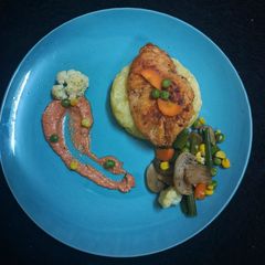 A picture of Chicken steak with tomato cheese sauce.
