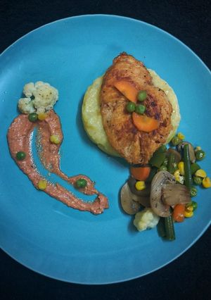 A picture of Chicken steak with tomato cheese sauce.