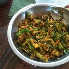 A picture of Egg curry with Fenugreek leaves and tomatoes.
