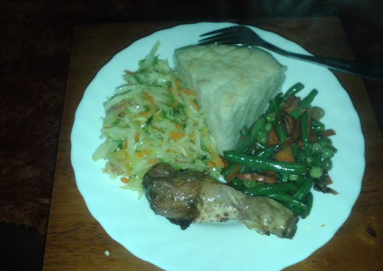 Ugali served with roasted chicken, steamed cabbage and mixed veggies