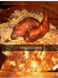 A picture of Vegetables Indomie with egg and fried chicken.