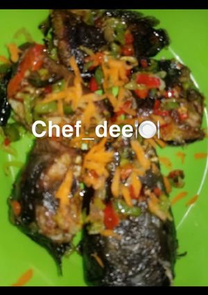 A picture of Fried fish with vegetables.