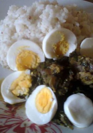 A picture of Ofada rice,Vegetable stew,beef and Boiled Eggs.