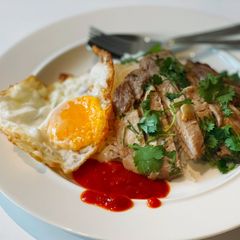 A picture of Grilled pork loin served with rice & fried egg.