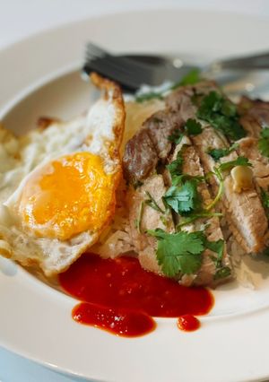 A picture of Grilled pork loin served with rice & fried egg.