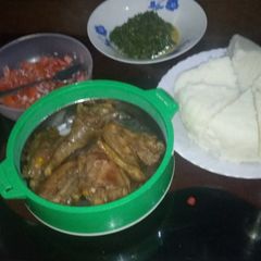 Ugali served with chicken and kales A picture of Ugali served with chicken and kales.