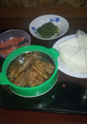 A picture of Ugali served with chicken and kales.