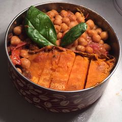 A picture of Miso chickpea curry with sweet potatoes wedges.
