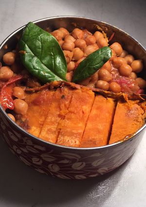 A picture of Miso chickpea curry with sweet potatoes wedges.