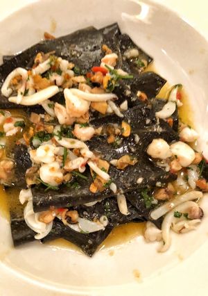 A picture of Black handkerchief pasta with cuttlefish, mussels, prawn and chilli.
