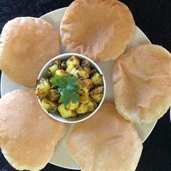 A picture of Jeera aloo with puri.