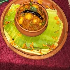 A picture of Spiced baby potato curry with tomato.