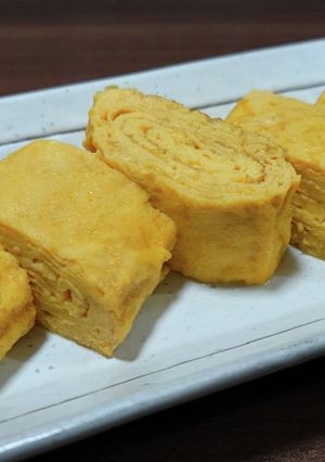 A picture of Juicy Savory Japanese Rolled Omelet (Dashi-Maki Tamago).