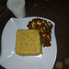 A picture of Jellof rice with spinach sauce.
