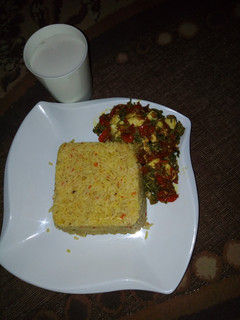 A picture of Jellof rice with spinach sauce.