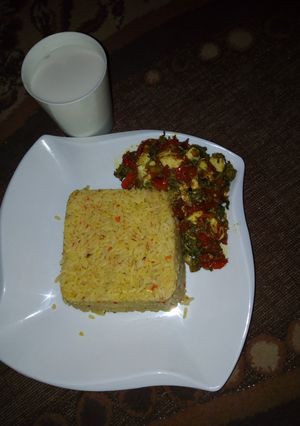 A picture of Jellof rice with spinach sauce.
