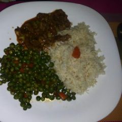A picture of Rice, Snow peas and beef stew.
