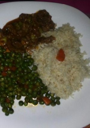 A picture of Rice, Snow peas and beef stew.