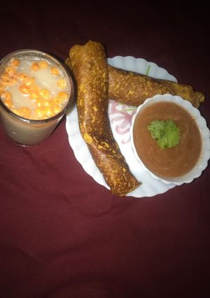 A picture of Onion cheela with tomato chutney and Masala Chaas.