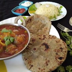 Kathiyavadi stuff onion with bajra roti and jeera rice A picture of Kathiyavadi stuff onion with bajra roti and jeera rice.