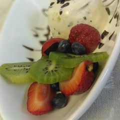 A picture of Blueberry vanilla ice cream with fruit mix.