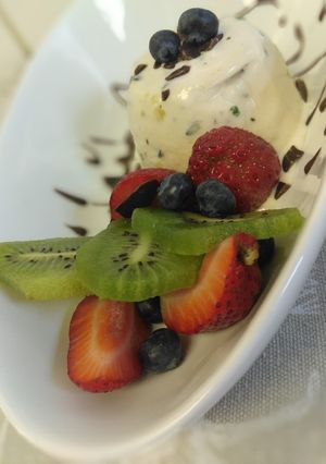 A picture of Blueberry vanilla ice cream with fruit mix.