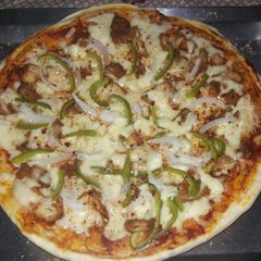 A picture of Homemade chicken tikka pizza.