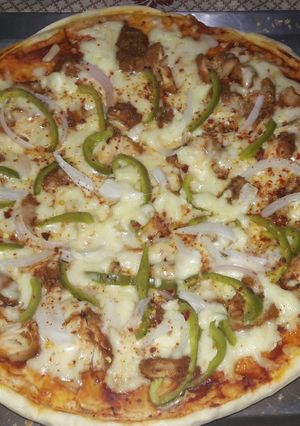 A picture of Homemade chicken tikka pizza.