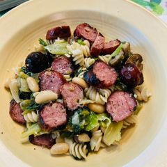 A picture of Smoked Chicken sausage, Escarole and beans over quinoa and brown rice pasta.