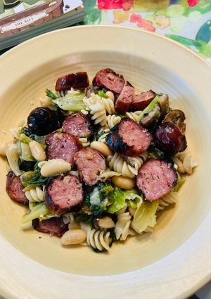 A picture of Smoked Chicken sausage, Escarole and beans over quinoa and brown rice pasta.