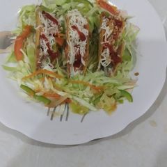 A picture of Mexican beans tacos with sour cream.