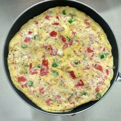 A picture of Omlette with tomatoes.