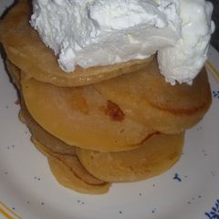 A picture of Pancakes topped with ice cream.