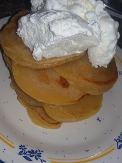 A picture of Pancakes topped with ice cream.