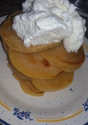 A picture of Pancakes topped with ice cream.