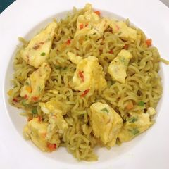 A picture of Noodles and fried omelette...Kiddies school lunch.