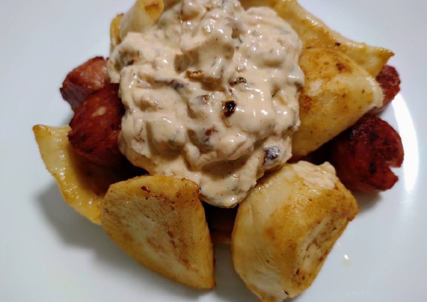 Pierogies and sausage with burnt onion cream