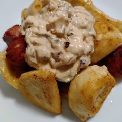 A picture of Pierogies and sausage with burnt onion cream.