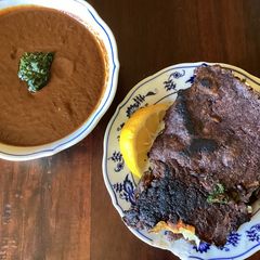 A picture of California Farm Quesa Birria Tacos and Consommé.