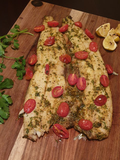 A picture of Masala snoek with roasted tomatoes.