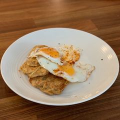 Potato hash browns with fried eggs A picture of Potato hash browns with fried eggs.