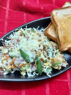 A picture of Scrambled Egg with Leftover Vegetables and Cheese.