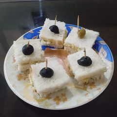 A picture of 1 bite club sandwich.