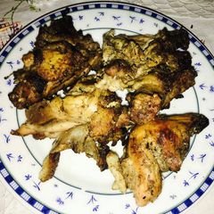A picture of Grilled chicken with charcoal.