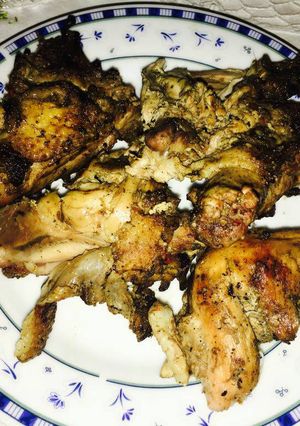 A picture of Grilled chicken with charcoal.