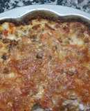Tortilla al horno con relleno de empanadas de jamón y queso y de carne